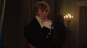 Movie still from “Emma.” (2020), directed by Autumn de Wilde – A man in a black jacket and white gloves; Medium shot, Over the shoulder angle