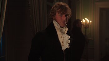 Movie still from “Emma.” (2020), directed by Autumn de Wilde – A man in a black jacket and white shirt; Medium shot, Over the shoulder angle