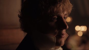 Movie still from “Emma.” (2020), directed by Autumn de Wilde – A person with curly hair wearing a white shirt; Close Up shot, Over the shoulder angle