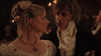 Movie still from “Emma.” (2020), directed by Autumn de Wilde – A man and a woman dressed in period garb looking at each other; Close Up shot, Over the shoulder angle