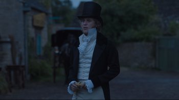 Movie still from “Emma.” (2020), directed by Autumn de Wilde – A man in a top hat and a black jacket; Medium shot, Over the shoulder angle
