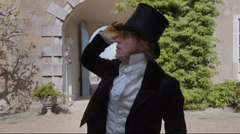 Movie still from “Emma.” (2020), directed by Autumn de Wilde – A man in a top hat and a black jacket; Medium shot, Low angle