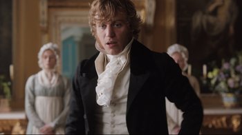 Movie still from “Emma.” (2020), directed by Autumn de Wilde – A man in a black jacket and white shirt; Medium shot, Over the shoulder angle