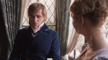 Movie still from “Emma.” (2020), directed by Autumn de Wilde – A man in a blue coat and a woman in a white dress; Medium shot, Over the shoulder angle