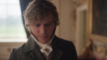 Movie still from “Emma.” (2020), directed by Autumn de Wilde – A man in a suit and tie looking down; Close Up shot, Over the shoulder angle