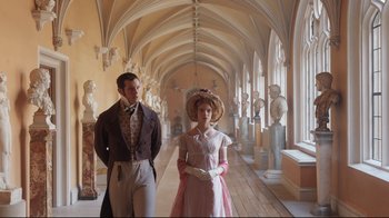 Movie still from “Emma.” (2020), directed by Autumn de Wilde – A man and a woman dressed in period clothing; Wide shot, Low angle