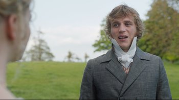 Movie still from “Emma.” (2020), directed by Autumn de Wilde – A young man wearing a suit and a neck tie; Close Up shot, Over the shoulder angle