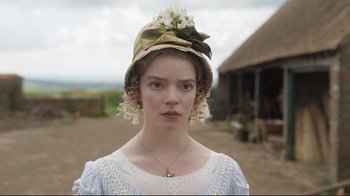 Movie still from “Emma.” (2020), directed by Autumn de Wilde – A young woman wearing a dress and a hat; Close Up shot, Over the shoulder angle