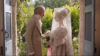 Movie still from “Emma.” (2020), directed by Autumn de Wilde – An older man and a young woman dressed in period clothing; Close Up shot, Over the shoulder angle