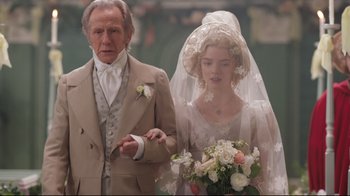 Movie still from “Emma.” (2020), directed by Autumn de Wilde – An older man and a young woman in wedding attire; Close Up shot, Over the shoulder angle