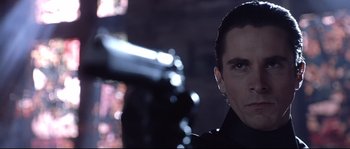 Movie still from “Equilibrium” (2002), directed by Kurt Wimmer – A person with a gun; Close Up shot, Low angle
