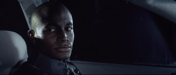 Movie still from “Equilibrium” (2002), directed by Kurt Wimmer – A person in a car at night; Close Up shot, Low angle