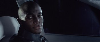 Movie still from “Equilibrium” (2002), directed by Kurt Wimmer – A person in a car at night; Close Up shot, High angle