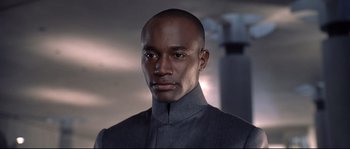 Movie still from “Equilibrium” (2002), directed by Kurt Wimmer – A man in a gray jacket is looking at the camera; Close Up shot, Low angle