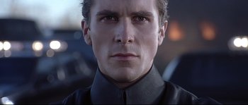 Movie still from “Equilibrium” (2002), directed by Kurt Wimmer – A person wearing a black shirt; Close Up shot, Low angle