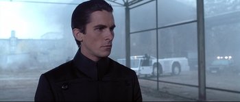 Movie still from “Equilibrium” (2002), directed by Kurt Wimmer – A man that is standing in the rain; Close Up shot, Over the shoulder angle