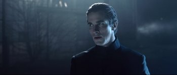 Movie still from “Equilibrium” (2002), directed by Kurt Wimmer – A man that is wearing a black suit; Close Up shot, Low angle