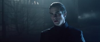 Movie still from “Equilibrium” (2002), directed by Kurt Wimmer – A person wearing a suit and tie; Close Up shot, Low angle