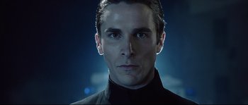 Movie still from “Equilibrium” (2002), directed by Kurt Wimmer – A person wearing a suit and tie; Close Up shot, Low angle