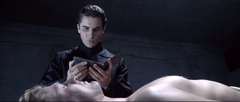 Movie still from “Equilibrium” (2002), directed by Kurt Wimmer – A man holding a knife in front of another man's face; Close Up shot, Overhead angle