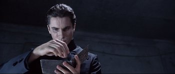 Movie still from “Equilibrium” (2002), directed by Kurt Wimmer – A man holding a knife in his hands; Close Up shot, Low angle