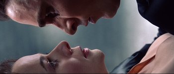 A man and a woman face to face in front of a sky background