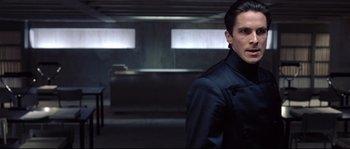 Movie still from “Equilibrium” (2002), directed by Kurt Wimmer – A man standing in a dark room; Medium shot, Over the shoulder angle