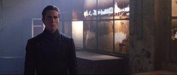 A man standing in front of a window in a room
