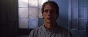 Movie still from “Equilibrium” (2002), directed by Kurt Wimmer – A person wearing a shirt; Close Up shot, Low angle