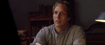 Movie still from “Equilibrium” (2002), directed by Kurt Wimmer – A person sitting in a chair; Close Up shot, Low angle