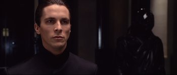 Movie still from “Equilibrium” (2002), directed by Kurt Wimmer – A person wearing a suit and tie; Close Up shot, Over the shoulder angle