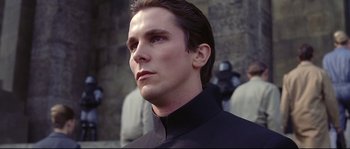 Movie still from “Equilibrium” (2002), directed by Kurt Wimmer – A person wearing a black shirt; Close Up shot, Low angle