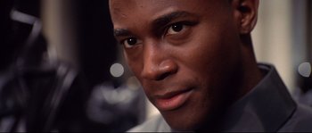 Movie still from “Equilibrium” (2002), directed by Kurt Wimmer – A man's face in a dark room; Close Up shot, Low angle