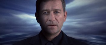 Movie still from “Equilibrium” (2002), directed by Kurt Wimmer – A person wearing a shirt and tie; Close Up shot, Low angle