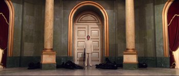 Movie still from “Equilibrium” (2002), directed by Kurt Wimmer – A man standing in front of an entrance to a building; Wide shot, High angle