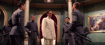 Movie still from “Equilibrium” (2002), directed by Kurt Wimmer – A group of men standing next to each other in a room; Medium shot, Low angle