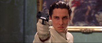 Movie still from “Equilibrium” (2002), directed by Kurt Wimmer – A man holding a gun in his hand; Close Up shot, Low angle