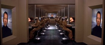 Movie still from “Equilibrium” (2002), directed by Kurt Wimmer – A computer room full of people wearing masks and sitting at computers; Wide shot, High angle