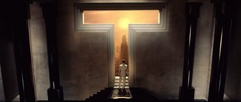 Movie still from “Equilibrium” (2002), directed by Kurt Wimmer – A man in a white suit standing in front of an open door; Extreme Wide shot, High angle