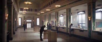 Movie still from “Free Guy” (2021), directed by Shawn Levy – A group of people standing in a room; Extreme Wide shot, Low angle