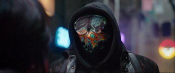 Movie still from “Free Guy” (2021), directed by Shawn Levy – A person wearing a mask with graffiti on it; Close Up shot, Low angle