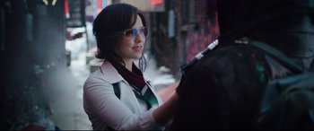Movie still from “Free Guy” (2021), directed by Shawn Levy – A woman in a white jacket holding a guitar; Close Up shot, Over the shoulder angle