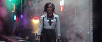 Movie still from “Free Guy” (2021), directed by Shawn Levy – A woman in a white shirt holding a sword; Medium shot, Over the shoulder angle