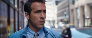 Movie still from “Free Guy” (2021), directed by Shawn Levy – A person wearing a suit and tie; Close Up shot, Over the shoulder angle