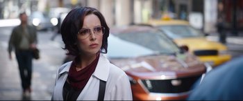 Movie still from “Free Guy” (2021), directed by Shawn Levy – A woman wearing glasses and a white coat; Close Up shot, Over the shoulder angle