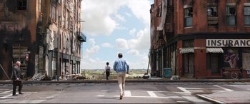 Movie still from “Free Guy” (2021), directed by Shawn Levy – A man and a woman cross the street in an urban setting; Wide shot, Low angle