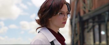 Movie still from “Free Guy” (2021), directed by Shawn Levy – A woman wearing glasses and a white coat; Close Up shot, Over the shoulder angle