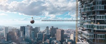 Movie still from “Free Guy” (2021), directed by Shawn Levy – An aerial view of a city with a bridge in the background; Extreme Wide shot, Overhead angle