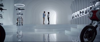 Movie still from “Free Guy” (2021), directed by Shawn Levy – Two people are standing in a room with a white wall; Wide shot, Low angle