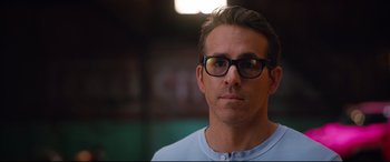 Movie still from “Free Guy” (2021), directed by Shawn Levy – A person wearing glasses; Close Up shot, Over the shoulder angle